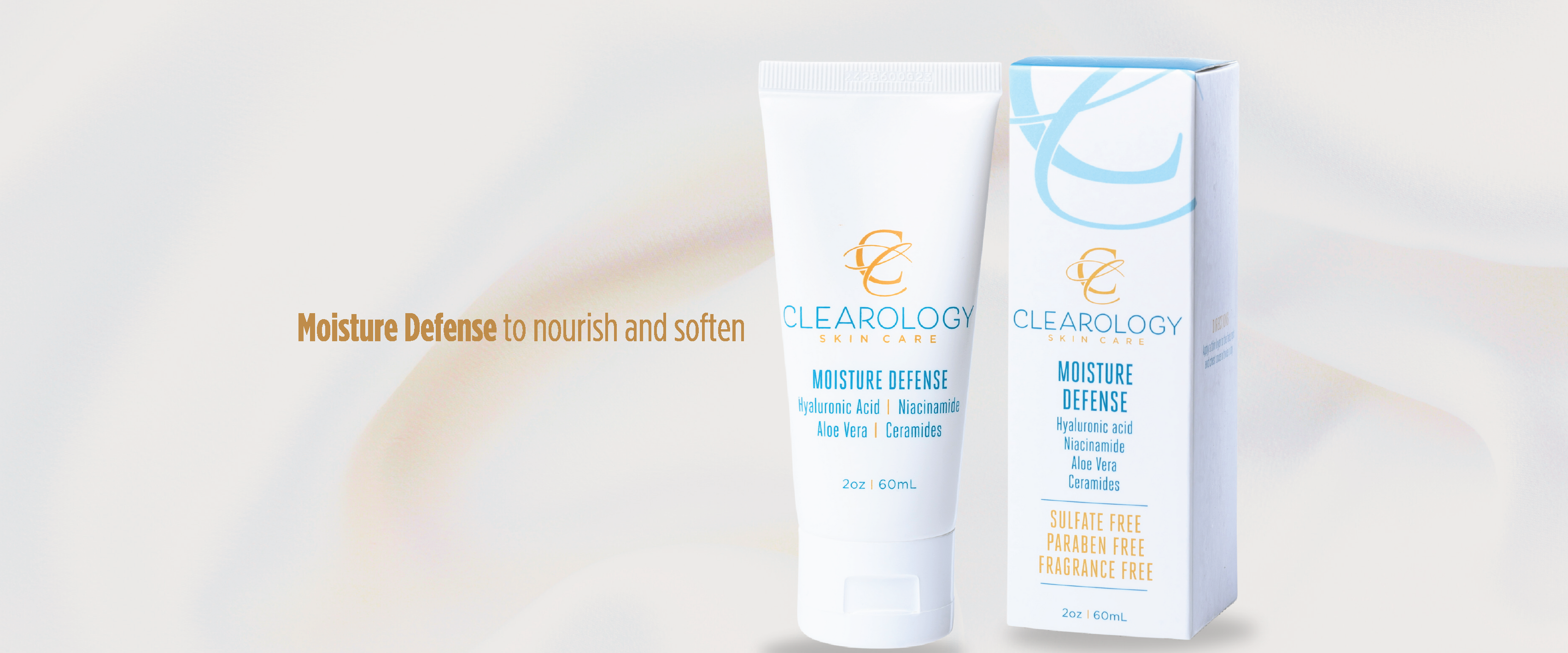 The image shows a tube and a box of skincare product named "Clearology Skin Care Moisture Defense." The tube is white with a blue and gold logo and text, while the box is similarly designed. The product contains Hyaluronic Acid, Niacinamide, Aloe Vera, and Ceramides. The text above the products reads, "Moisture Defense to nourish and soften." The product is labeled as sulfate-free, paraben-free, and fragrance-free, and the size of the tube is 2 oz (60 mL).