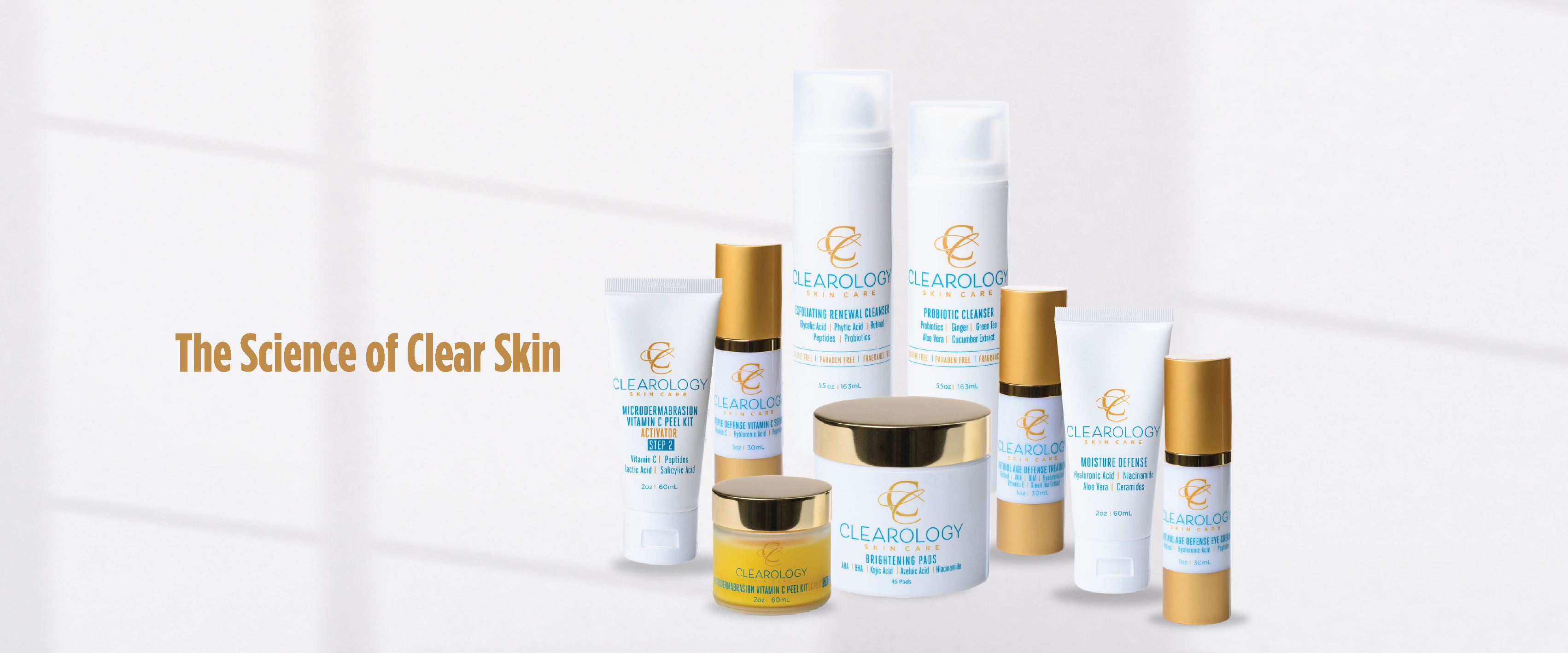 The image shows a collection of skincare products from Clearology Skin Care, created by dermatologists in Baton Rouge. The products are arranged in a neat display and include various types of cleansers, creams, and treatments. The product range features white packaging with blue and gold accents. Text to the left of the products reads, "The Science of Clear Skin." The products are labeled as sulfate-free, paraben-free, and fragrance-free, emphasizing their dermatologist-developed formulations.